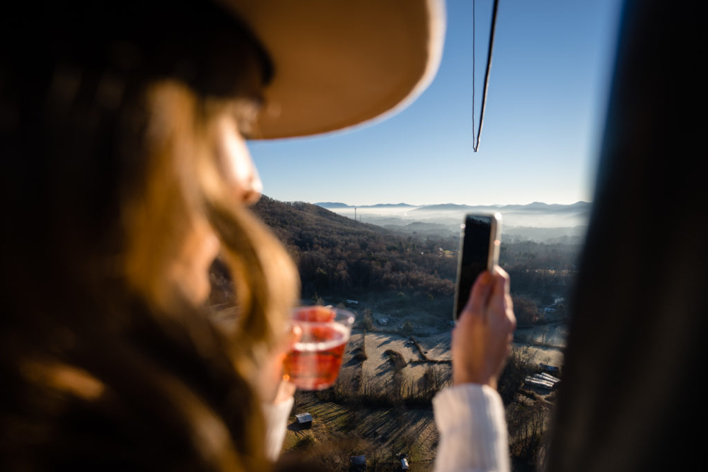 Bride taking selfies during hot air balloon ride by Nathan Whitworth Greenville SC Wedding Photography